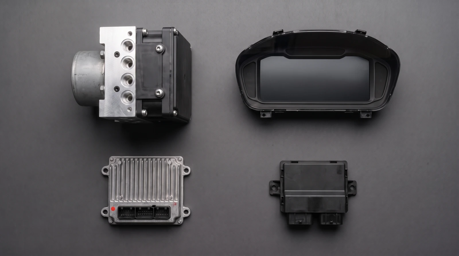 ABS unit, instrument cluster and steering control module laid out on a workbench