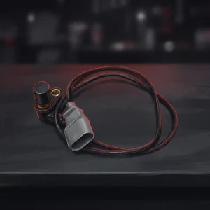 Illustration of an ABS wheel speed sensor with its mounting flange, cable and two-pin plug on a workshop bench