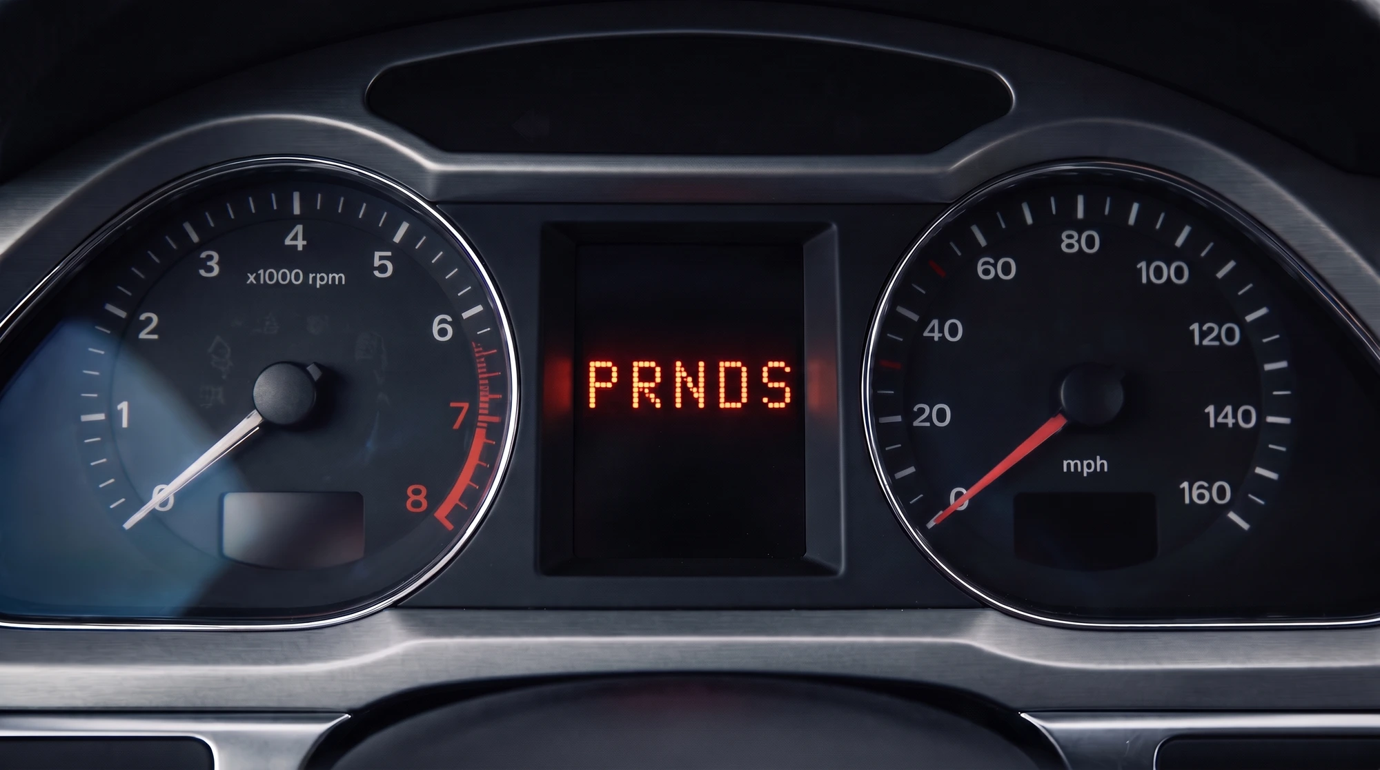 Close-up of a VW/Audi DSG instrument cluster's small central display with PRNDS all illuminated together, the classic gearbox mechatronic fault symptom