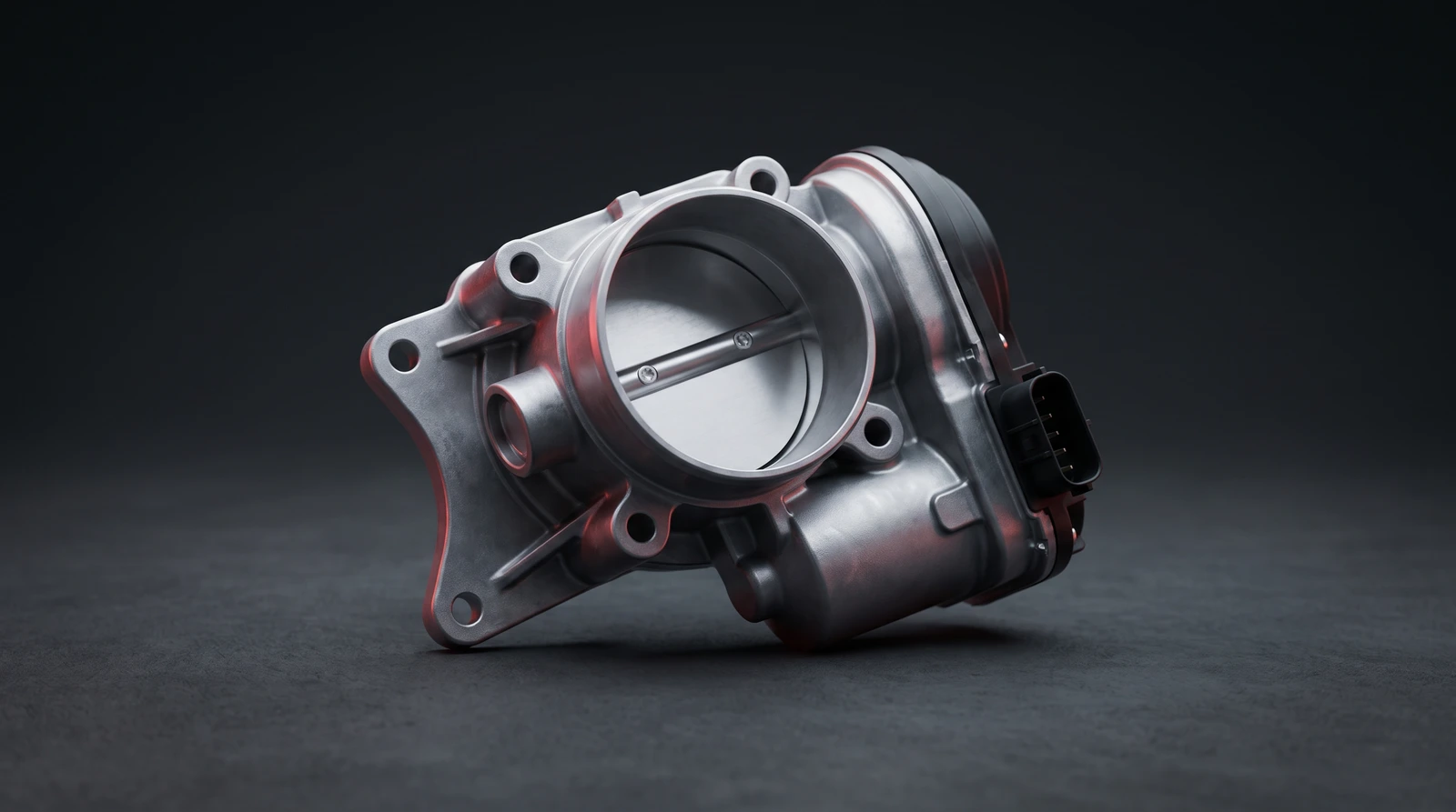 Wide studio shot of an electronic throttle body, showing the plate, spindle and connector